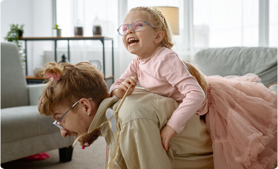 Girl playing on father's back