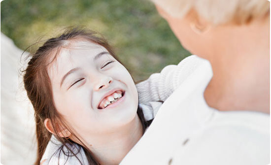 Girl smiling with caregiver