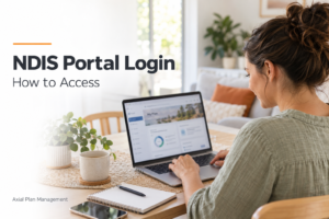 Woman using a laptop to access NDIS plan information at home.